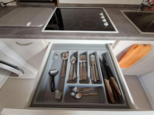 a kitchen sink with utensils in a drawer at Cozy 1 Bedroom House in Iz-Zejtun in Żejtun