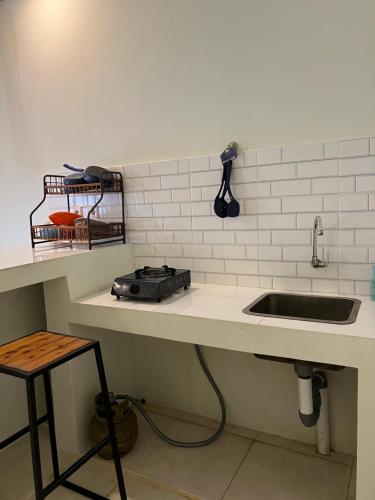 a kitchen with a sink and a counter with a sink at Kuta Circle Homestay in Kuta Lombok