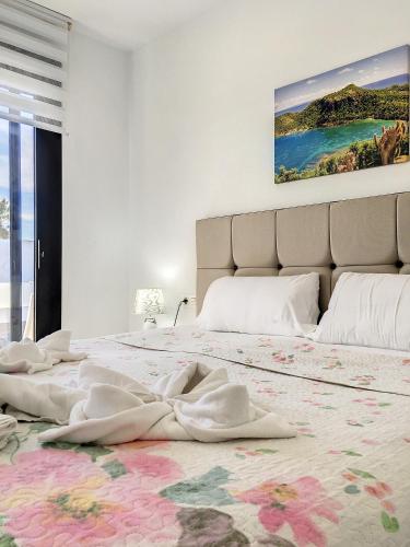 a white bedroom with a large bed with a rug at Villa Sur - Sucina - 8409 in Sucina