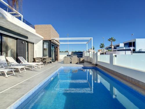 a swimming pool on the side of a house at Villa Sur - Sucina - 8409 in Sucina