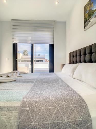 a bedroom with a large bed and a view of the ocean at Villa Sur - Sucina - 8409 in Sucina