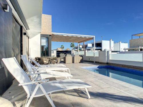a group of chairs sitting on the roof of a house at Villa Sur - Sucina - 8409 in Sucina