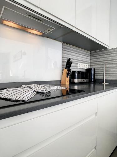 a kitchen with white cabinets and a black counter top at Villa Sur - Sucina - 8409 in Sucina