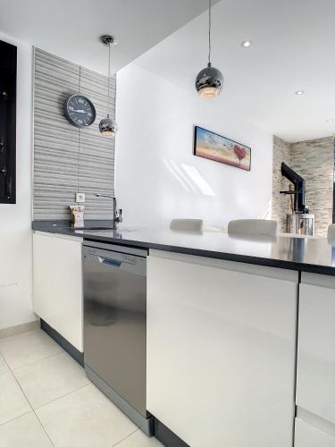 a kitchen with white cabinets and a counter top at Villa Sur - Sucina - 8409 in Sucina