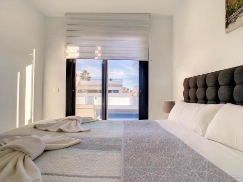 a bedroom with a large bed with a large window at Villa Sur - Sucina - 8409 in Sucina