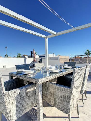a table with chairs and an umbrella on a patio at Villa Sur - Sucina - 8409 in Sucina