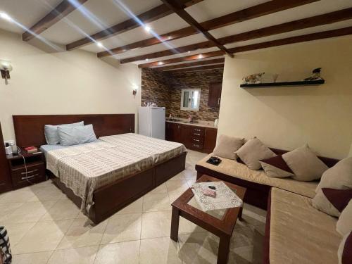 a bedroom with a bed and a couch in a room at Studio 2 in Sharm El Sheikh