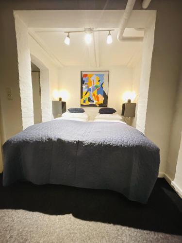 a large bed in a room with two lamps at aday - Modern apartment in the Heart of Aalborg in Aalborg