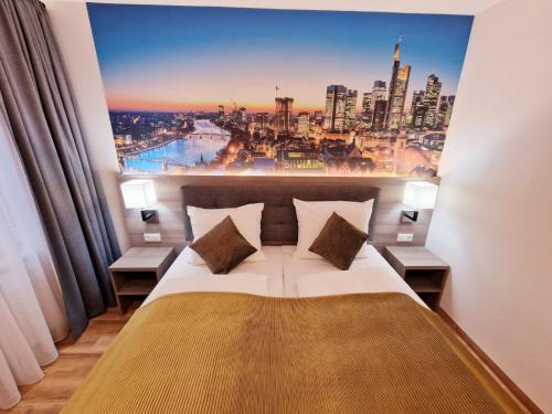 a bedroom with a large poster of a city at Hotel Frankfurt Messe in Frankfurt