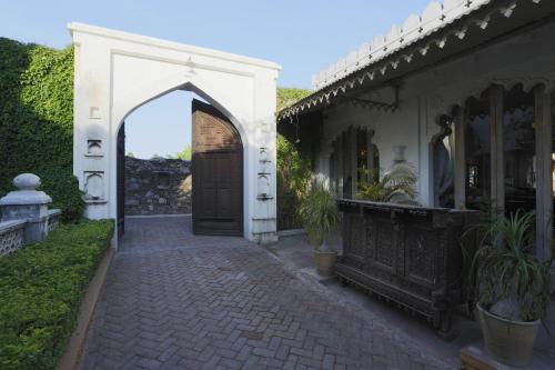 an entrance to a white building with a door at The Rawla Narlai - A Luxury Heritage Stay in Leopard Country in Nārlāi