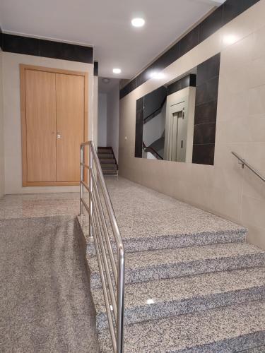 a stairway with a mirror and a stair case at Piso Prol in Ourense
