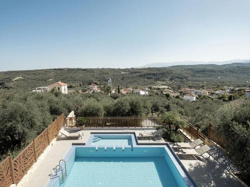 a swimming pool in a villa with a view at Villa Hibiscus in Spiliá