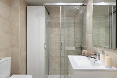 a bathroom with a shower and a sink and a toilet at Casa Joyne in Puerto del Carmen