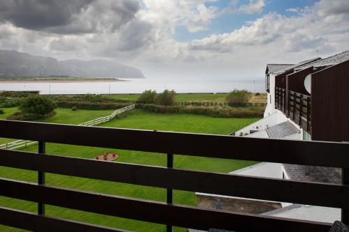 a view of the water from the balcony of a building at Rivage - Modern Maisonette in Deganwy