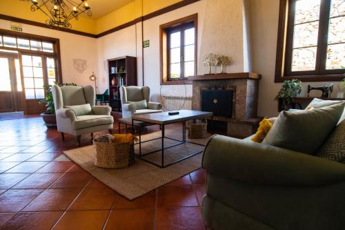 sala de estar con sofás y chimenea en Hotel El Tejar & Spa, en Vilaflor
