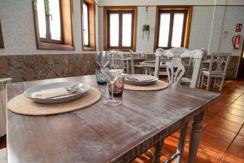 a wooden table with plates and glasses on top of it at Hotel El Tejar & Spa in Vilaflor