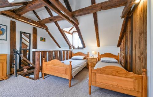 two beds in a room with wooden beams at Gorgeous Home In Sveti Ivan Zelina With Jacuzzi in Sveti Ivan Zelina