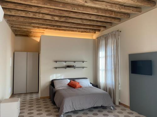 a bedroom with a bed with a wooden ceiling at Palazzo Fritz in Badia Calavena