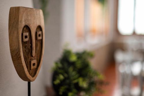 a wooden object on a wall next to a plant at Hotel El Tejar & Spa in Vilaflor