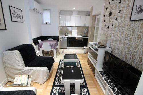 a living room with a couch and a table at Dučić Apartment in Trebinje