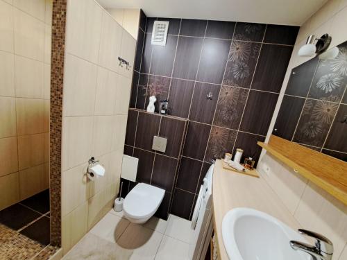 a bathroom with a toilet and a sink at Upes apartamenti Nr: 32 in Valmiera