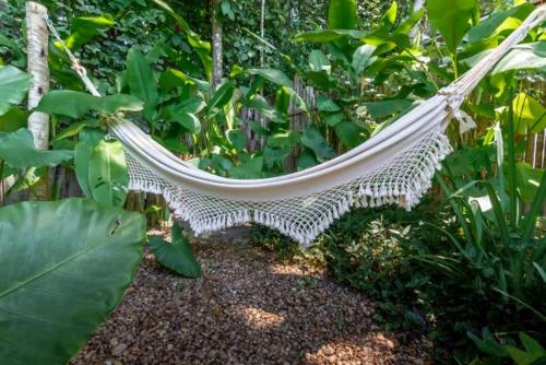 a white hammock in the middle of a forest at DA GRAÇA HOTEL in Trancoso