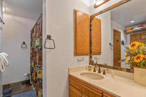 a bathroom with a sink and a mirror at The Aspen Glow in Durango Mountain Resort