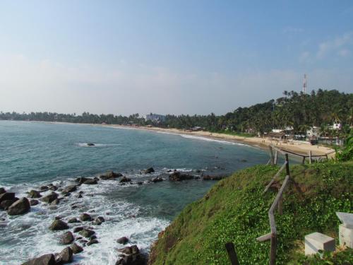 a view of a beach with rocks in the water at Bentota Home Stay in Bentota