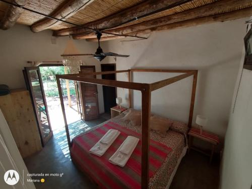 a bedroom with a bed with two towels on it at Chakana Hospedaje Rural in Villa Unión