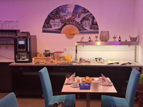 a table with chairs and a table with food on it at Gästehaus Alpina in Berchtesgaden