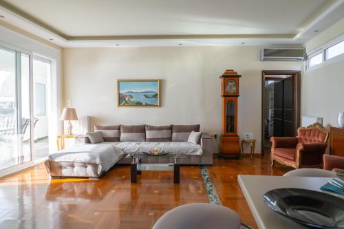 a living room with a large bed and a clock at Villa Seaside View in Volos