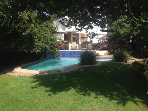 a swimming pool in the yard of a house at Lucky Bean Guesthouse in Johannesburg