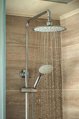 a shower with a shower head with water in it at Maleme Mare in Maleme