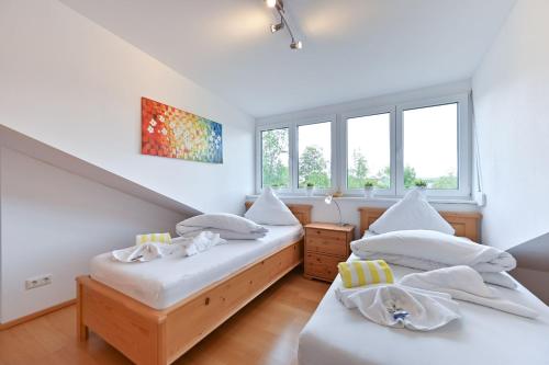 2 camas en una habitación con 2 ventanas en Chalet am Breitenberg Appartement CB 09 en Pfronten