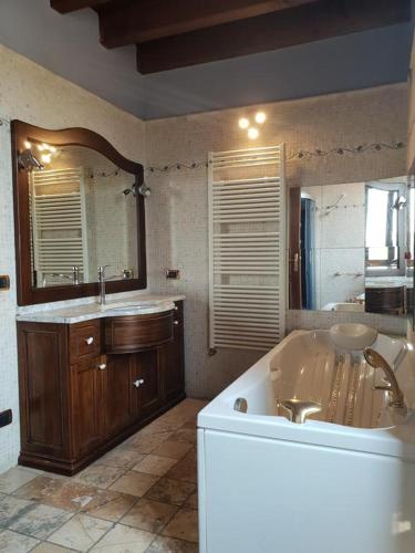 a large bathroom with a tub and a sink at Garda Family House in Desenzano del Garda