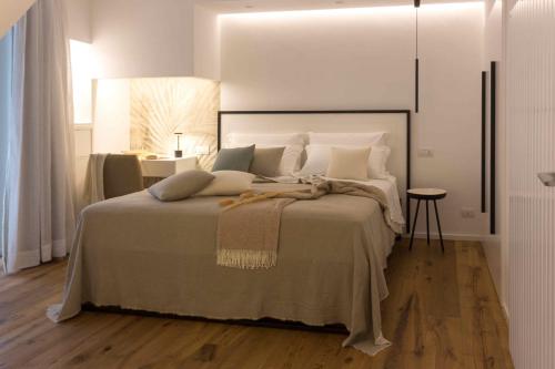 a bedroom with a large bed with white pillows at Zia Maria in Fasano