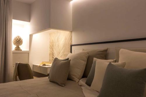 a bedroom with a bed with pillows and a table at Zia Maria in Fasano