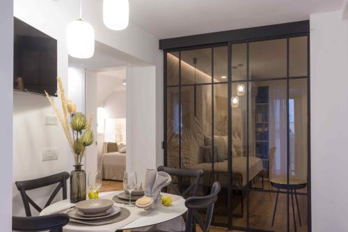 a dining room with a table and chairs and a living room at Zia Maria in Fasano