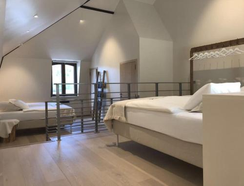 布永的住宿－La Relique ( woning voor 4 tot 6 personen )，一间带两张床的卧室和一个阳台