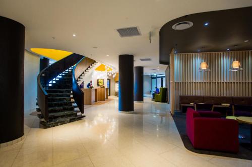 a lobby with a spiral staircase in a building at Park Inn by Radisson Libreville in Libreville