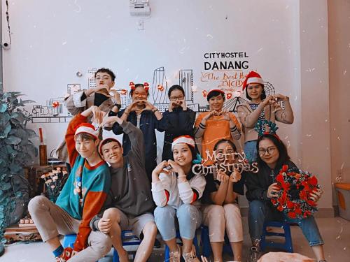 a group of people are posing for a picture at City Hostel Da Nang in Da Nang