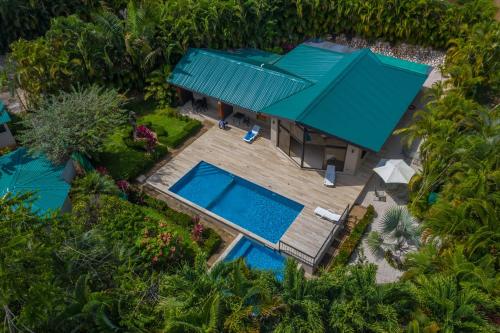an overhead view of a house with two swimming pools at Leyenda Boutique Hotel & Spa in Sámara