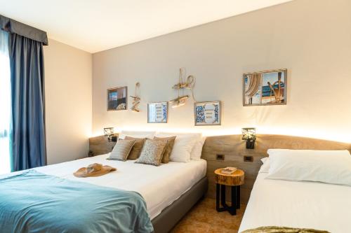 a hotel room with two beds at Ancora Sport Resort Hotel in Meolo