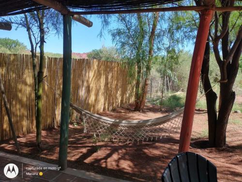 a hammock in a backyard with a fence at Chakana Hospedaje Rural in Villa Unión