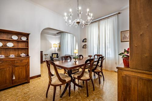 a dining room with a wooden table and chairs at YiD Leopolda apt few minutes from Central Station in Florence