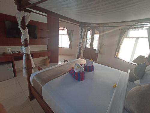 Ένα ή περισσότερα κρεβάτια σε δωμάτιο στο Kusnadi Hotel