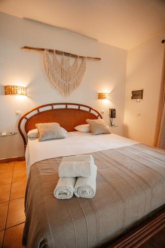 Una cama o camas en una habitación de Residence AU 'TI SUCRIER