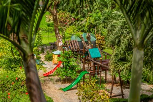 a garden with chairs and a swing at Leyenda Boutique Hotel & Spa in Sámara