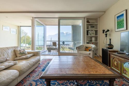 a living room with a couch and a table at Lakeside-Apartment-1 Grand appartement familial avec 2 terrasses et vue panoramique in Vevey