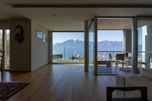 a living room with a view of the mountains at Lakeside-Apartment-1 Grand appartement familial avec 2 terrasses et vue panoramique in Vevey